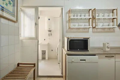 a kitchen with a counter top with a microwave at Paso del Mar Ha Apartment in Cádiz