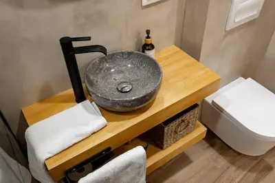 a bathroom with a sink on a wooden table at Apartamento Chanca - Ole Solutions in El Puerto de Santa María