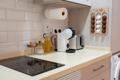 a kitchen with a coffee maker on a counter at Apartamento Chanca - Ole Solutions in El Puerto de Santa María