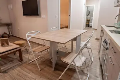a kitchen with a table and chairs in a room at Apartamento Chanca - Ole Solutions in El Puerto de Santa María