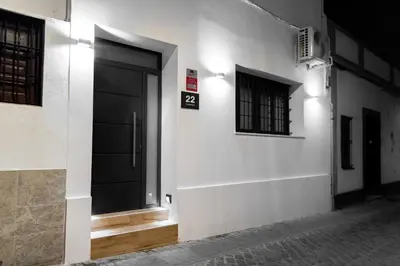 a black door on a white building with windows at Apartamento Chanca - Ole Solutions in El Puerto de Santa María