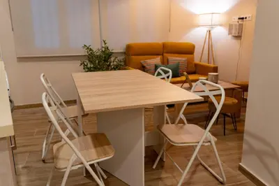 a table and chairs in a living room at Apartamento Chanca - Ole Solutions in El Puerto de Santa María