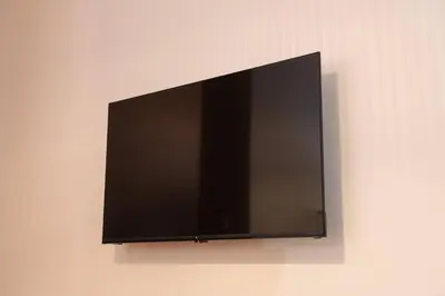 a flat screen tv hanging on a wall at Apartamento Chanca - Ole Solutions in El Puerto de Santa María