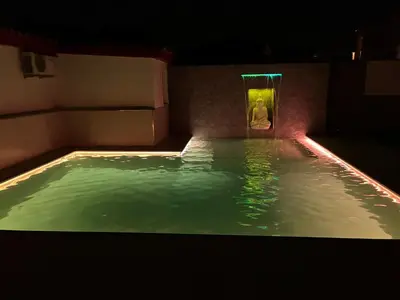 a pool of water with a person in the shower at Chalet Empul Las Marismas in Chiclana de la Frontera
