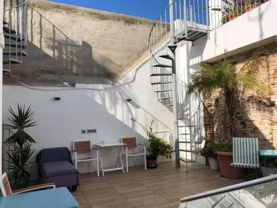a bedroom with a bed and a tv in it at Apartamentos Rosario Centro in Cádiz