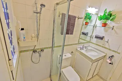 a bathroom with a shower and a toilet and a sink at Central & Style - Bars and Restaurants all around Apartment in El Puerto de Santa María