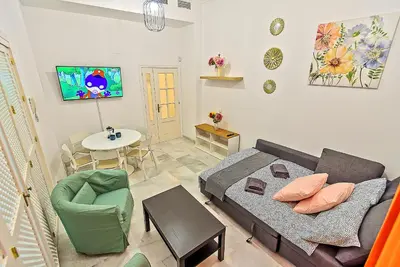 a living room with a bed and a couch and a table at Central & Style - Bars and Restaurants all around Apartment in El Puerto de Santa María