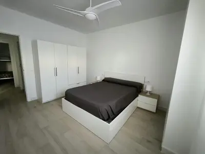 a bedroom with a bed and a ceiling fan at Happiness in San Fernando