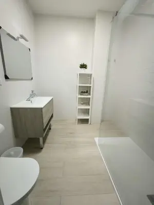 a white bathroom with a sink and a mirror at Happiness in San Fernando