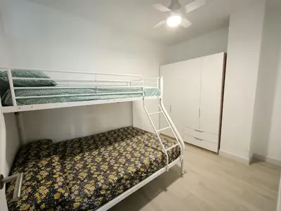 a bedroom with two bunk beds and a ceiling at Happiness in San Fernando
