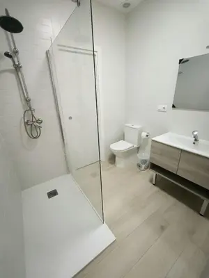 a bathroom with a glass shower and a toilet at Happiness in San Fernando