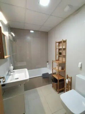 a bathroom with a sink and a tub and a toilet at Dunas de Punta Candor in Rota