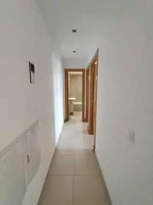 a hallway of a room with white walls and a bathroom at Dunas de Punta Candor in Rota