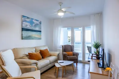 a living room with a couch and a chair at Balcón de Santa María Free Parking by Cádiz Time in Cádiz