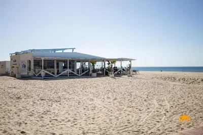 a building on the beach next to the ocean at Balcón de Santa María Free Parking by Cádiz Time in Cádiz