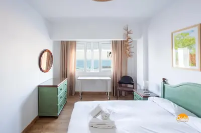 a bedroom with a bed and a desk and a window at Balcón de Santa María Free Parking by Cádiz Time in Cádiz