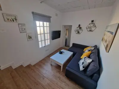 a living room with a couch and a table at Casa Consuelo in Jerez de la Frontera