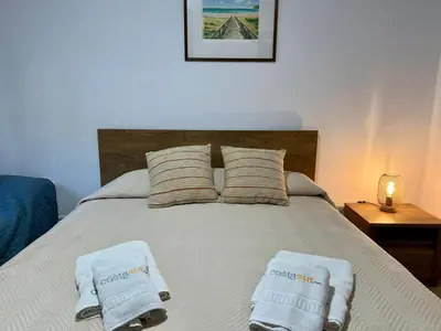 a bedroom with a bed with two towels on it at Los Porches in Chiclana de la Frontera