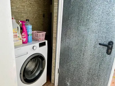 a washing machine in a bathroom with a washer at Los Porches in Chiclana de la Frontera
