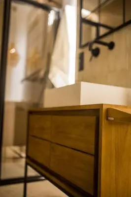 a kitchen with a wooden dresser and a mirror at Apartamento premium Prioral in El Puerto de Santa María