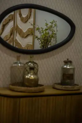 a mirror above a table with a vase and a tea kettle at Apartamento premium Prioral in El Puerto de Santa María