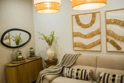 a living room with a couch and a mirror at Apartamento premium Prioral in El Puerto de Santa María
