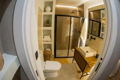a small bathroom with a toilet and a sink at Apartamento premium Prioral in El Puerto de Santa María