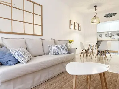 a white living room with a couch and a table at Casa Quili Cádiz com in Cádiz