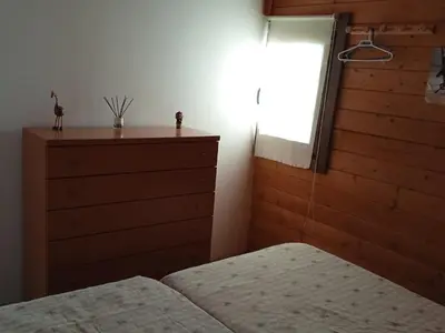 a bedroom with a bed and a window and a dresser at Centro ecuestre Girasol in Chiclana de la Frontera