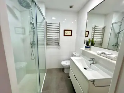 a bathroom with a shower and a toilet and a sink at GATU Arena 