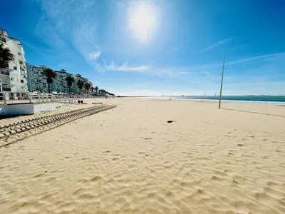 a sandy beach with a flag in the middle of it at GATU Arena 