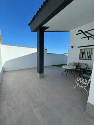 a patio with a table and chairs on a building at Lurasejo in Cádiz