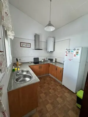 a kitchen with a sink and a white refrigerator at Lurasejo in Cádiz