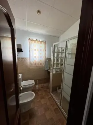 a bathroom with a toilet and a glass shower at Lurasejo in Cádiz
