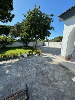 a bench sitting on a stone walkway in a yard at Lurasejo in Cádiz