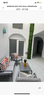 a picture of a patio with couches and a plant at SOTAVENTO La Solera in Sanlúcar de Barrameda