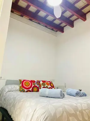 a bedroom with a bed with pillows and a ceiling at SOTAVENTO La Solera in Sanlúcar de Barrameda