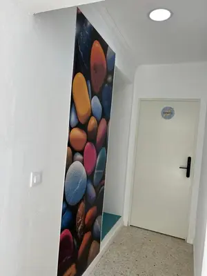 a hallway with a wall mural of planets at SOTAVENTO La Solera in Sanlúcar de Barrameda