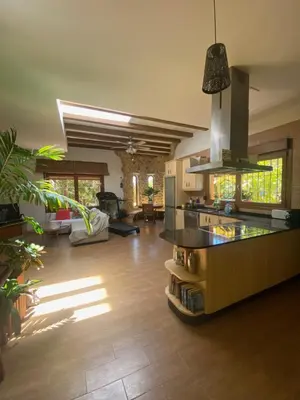 a large living room with a kitchen and a living room at House near Conil with a Tropical Garden and Pool in Conil de la Frontera