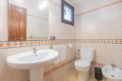 a white bathroom with a sink and a toilet at Moon Dreams Puerto in El Puerto de Santa María