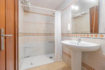 a bathroom with a shower and a sink and a tub at Moon Dreams Puerto in El Puerto de Santa María