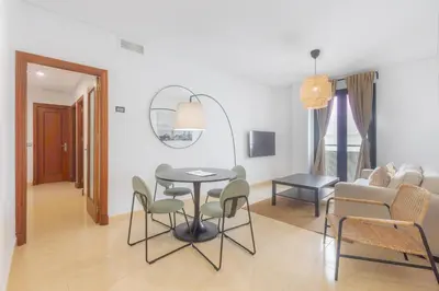 a living room with a table and chairs and a couch at Moon Dreams Puerto in El Puerto de Santa María