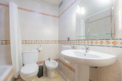 a white bathroom with a sink and a toilet at Moon Dreams Puerto in El Puerto de Santa María