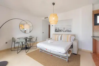 a bedroom with a bed and a table in it at Moon Dreams Puerto in El Puerto de Santa María