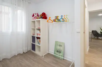 a room with a book shelf with shoes on it at Apartoyou - Ruiseñor Puerto in El Puerto de Santa María