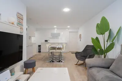 a living room with a couch and a table at Apartoyou - Ruiseñor Puerto in El Puerto de Santa María