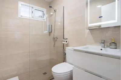 a bathroom with a toilet and a sink and a shower at Apartoyou - Ruiseñor Puerto in El Puerto de Santa María