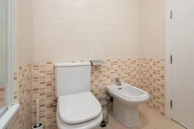 a bathroom with a toilet and a sink at Apartoyou - Estudio del Sol in El Puerto de Santa María