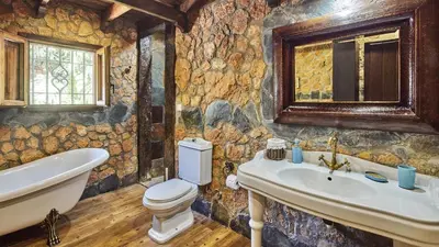 a stone bathroom with a toilet and a sink at Casa García Camacho Conil de la Frontera by Ruralidays in Conil de la Frontera