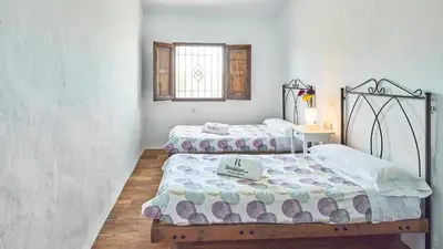 a bedroom with two beds and a window at Casa García Camacho Conil de la Frontera by Ruralidays in Conil de la Frontera